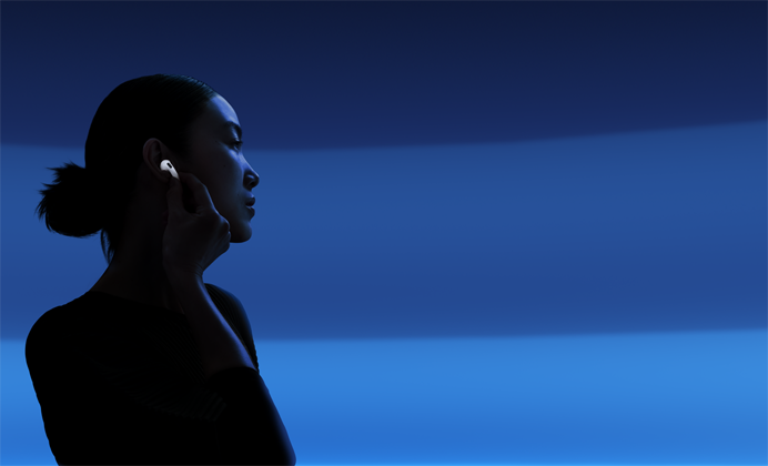 A person with their thumb and pointer finger holding the stem of their AirPods 5 to change listening modes