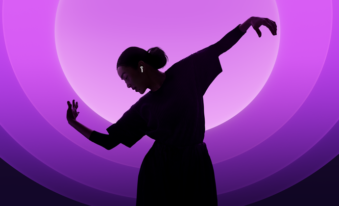 A person dancing while wearing AirPods 5, multi-color background