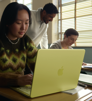 A student uses MacBook Neo, citrus color, unplugged in a classroom setting