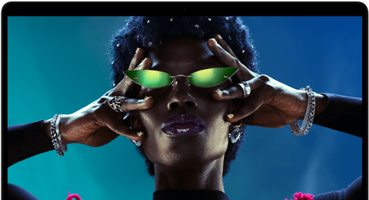 Colorful screen on a MacBook Pro of a person crowd-surfing at a party, showcasing the vibrant Liquid Retina XDR display